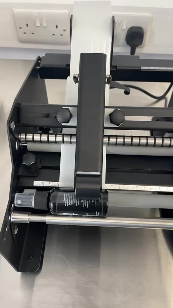 Close-up reel of bottle labelling applicator at The Filling Lab